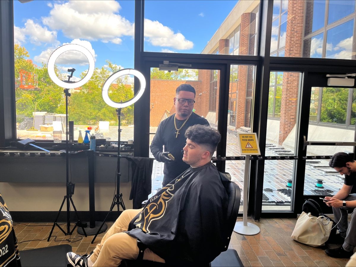 Student receiving a free haircut from Grand Master Kutz. - Contributor / Chris Calo