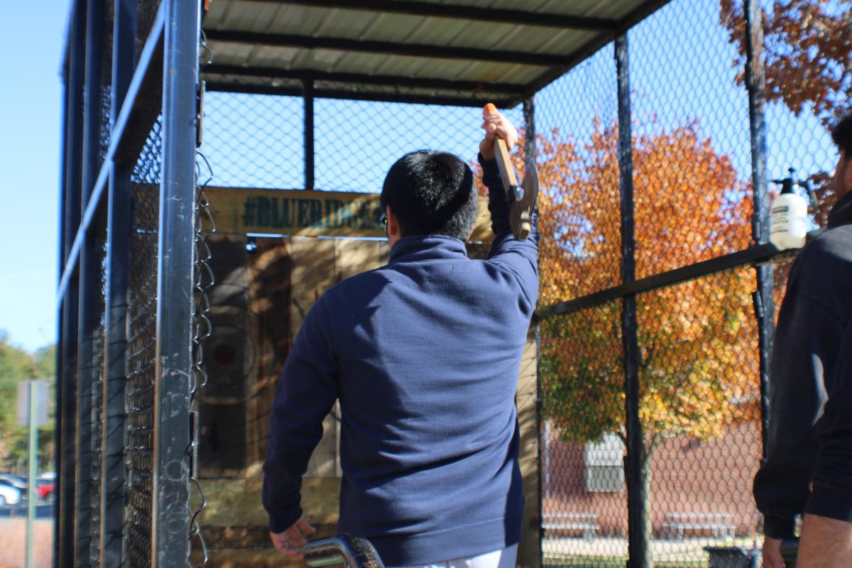 A student throws an axe at the Homecoming Kickoff. - Staff Photographer / Grady Stefankiewicz