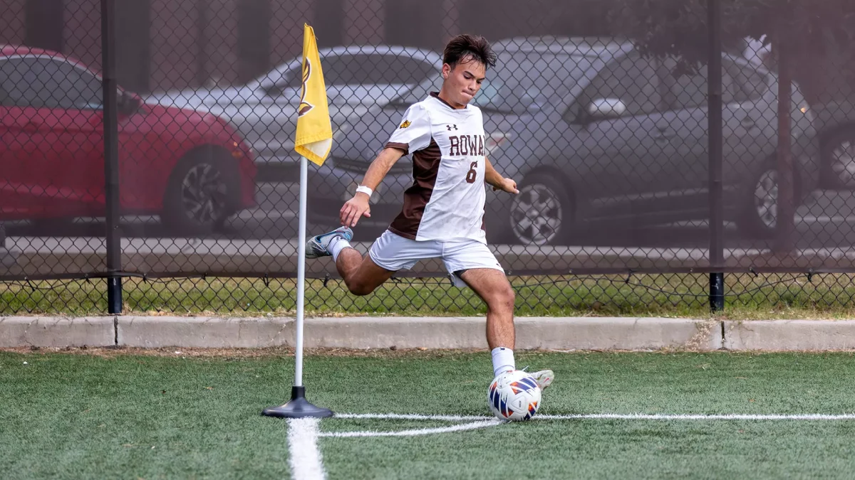 Jake Homowitz kicks a corner. Homowitz recorded a goal and assist in the win over William Paterson. - Photo via Rowan Athletics