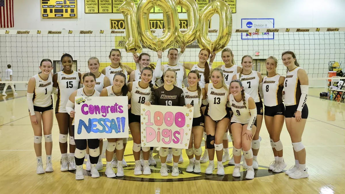 Rowan volleyball celebrating Vanessa Hutchinson reaching 1,000 career digs. - Photo via Rowan Athletics