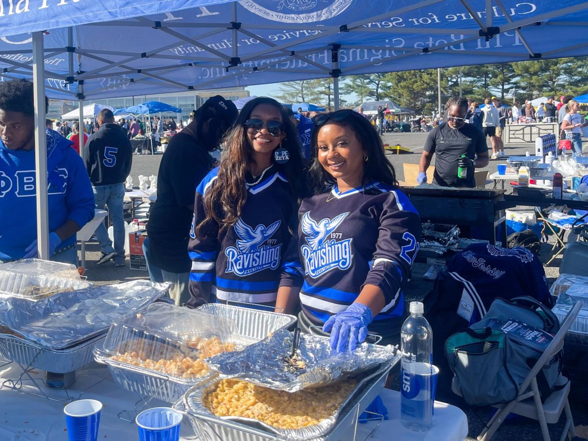 Members of Phi Beta Sigma barbecue at the homecoming tailgate. - Copy Editor / Marchella Mazzoni