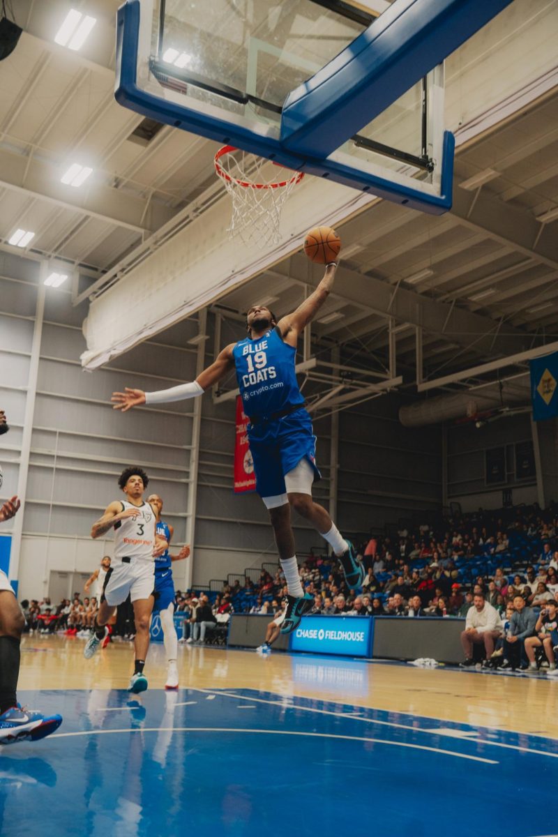 Justin Edwards skies towards the hoop for a dunk. In his debut against Maine, the first-year pro scored a game-high 28 points. - Photo via Shamar Swann