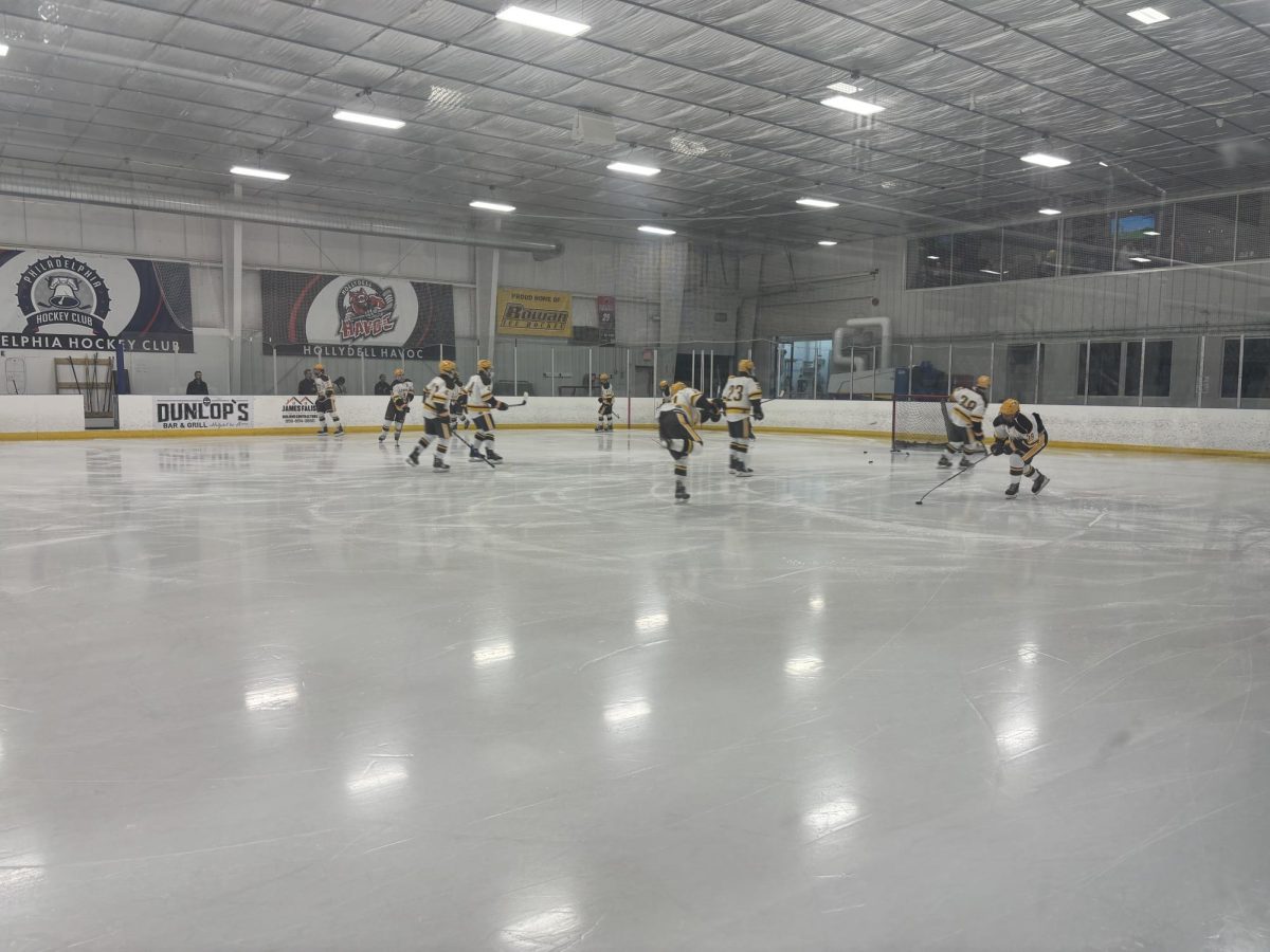 The team shoots the puck around at practice. - Photo / Eric Czerwonka