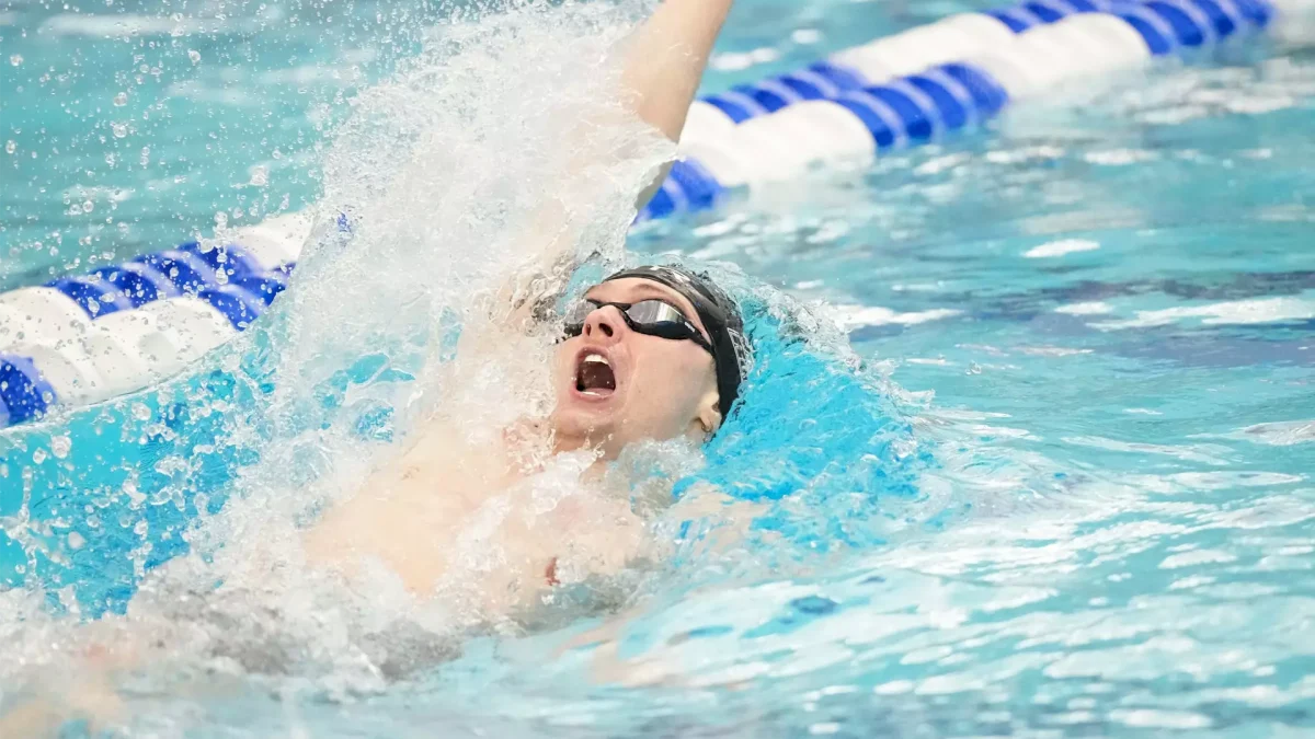 Jack Watson competes in the backstroke. Watson won the 100 and 200 backstroke. - Photo via Rowan Athletics