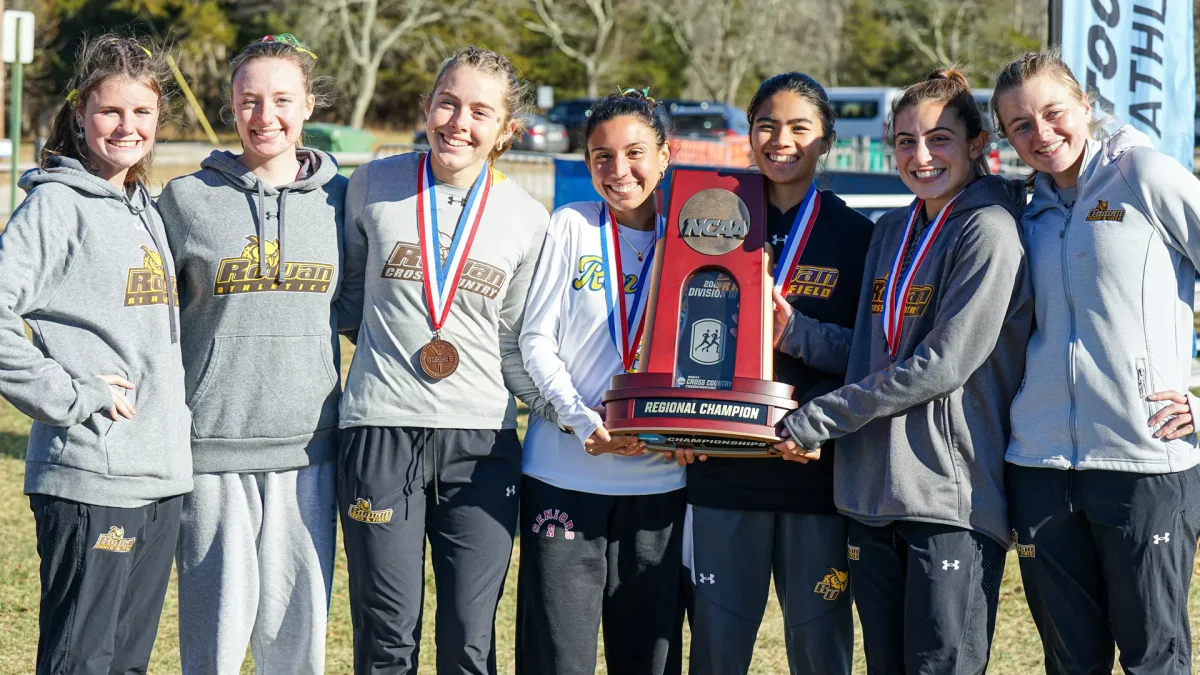 The team celebrates with the trophy. - Photo via Rowan Athletics