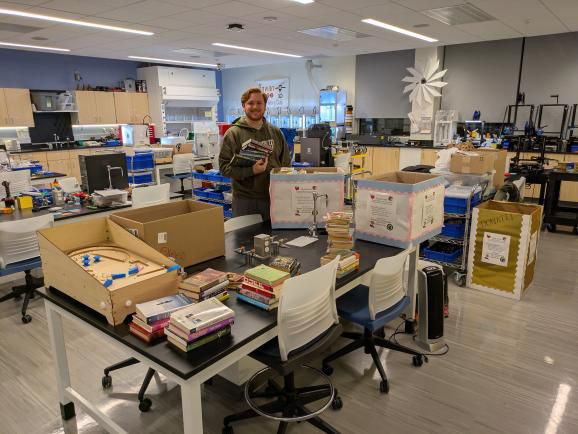 The 3D Printing Club organizes books for the drive. - Photo via the 3D Printing Club. 