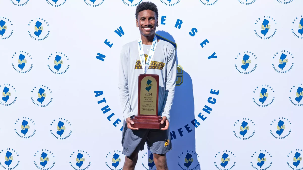 Senior standout Joshua Cason poses with the NJAC Championship trophy. - Photo via Rowan Athletics