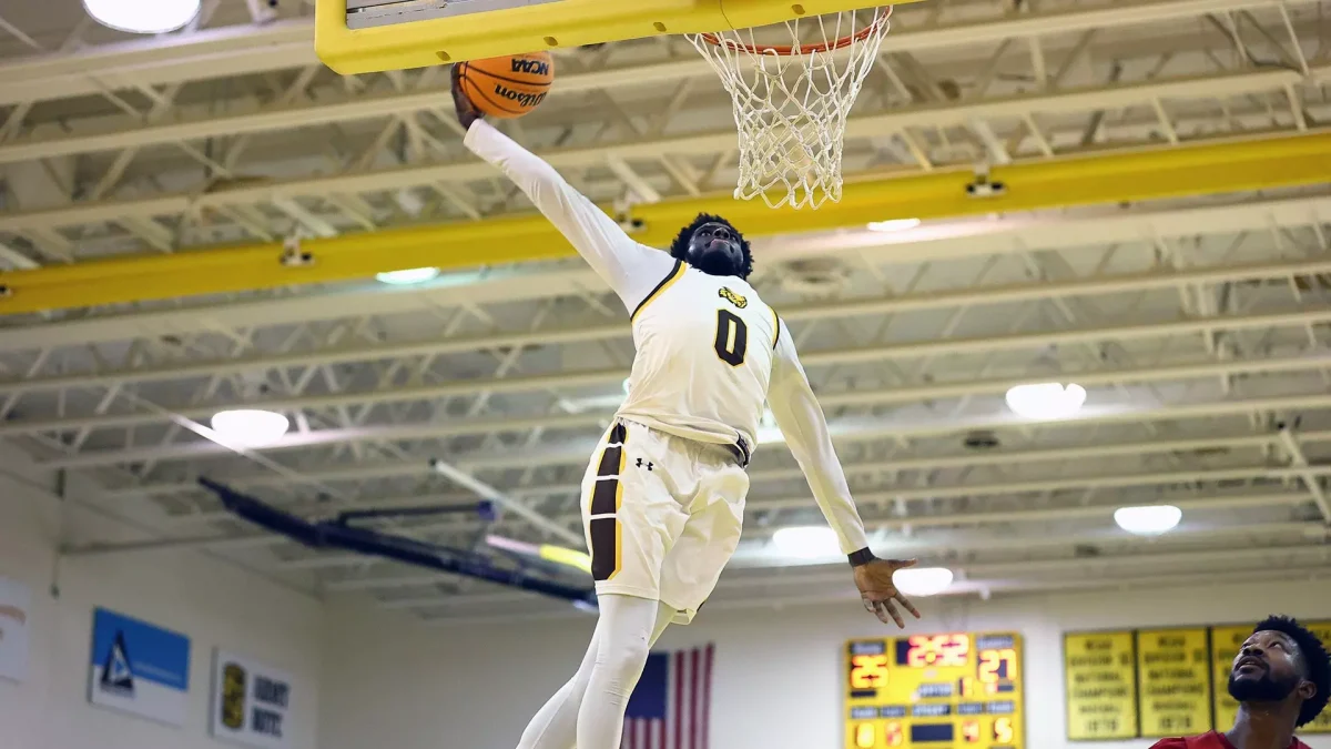 Khalif Meares rises for a dunk. Meares is just one of the six Profs returning this year. - Photo via Rowan Athletics