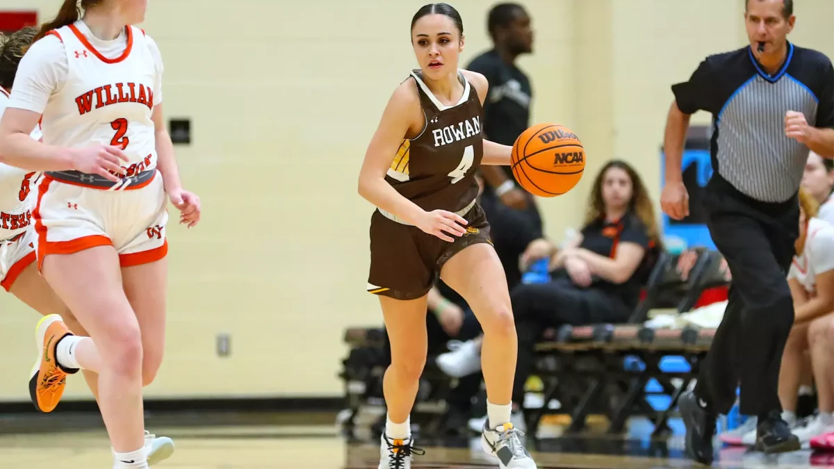 Sabrina Araujo brings the ball up the court. Araujo tallied 13 points in the win. - Photo via Rowan Athletics