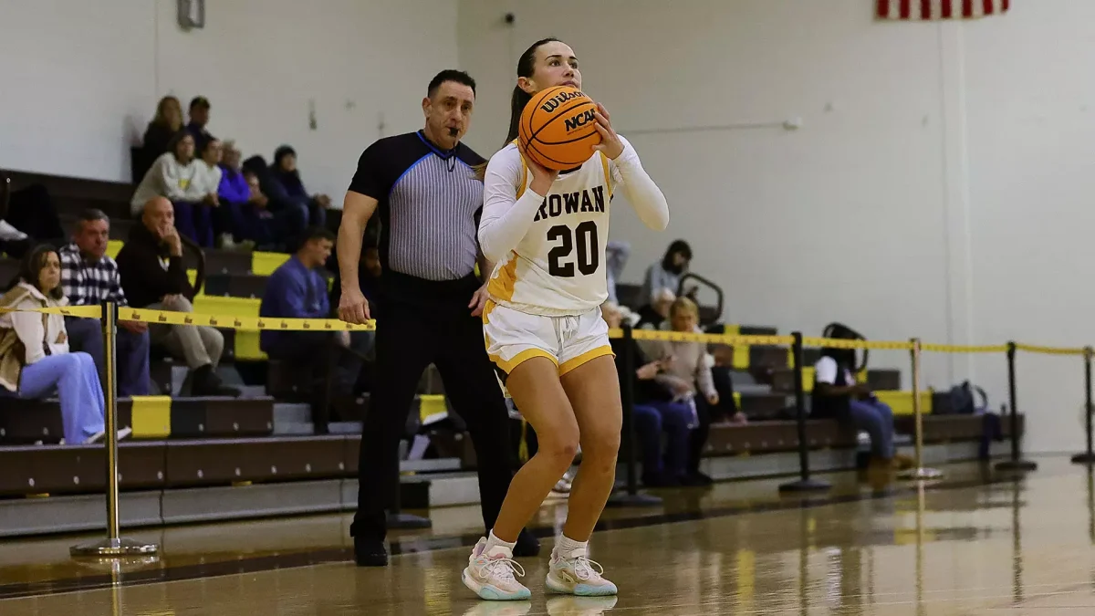 Kate Herlihy spots up for a three. Herlihy dropped 16 in the win over Rutgers-Camden. - Photo via Rowan Athletics