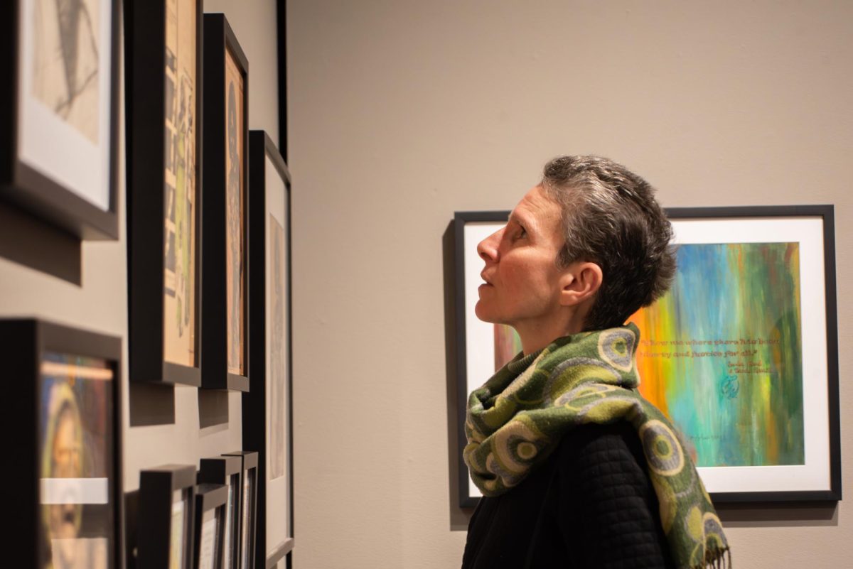 Professor Allison Parker looks at art in the Rowan Art Gallery. Glassboro, NJ. Saturday, Feb. 8, 2025. - Contributor / Kacie Scibilia