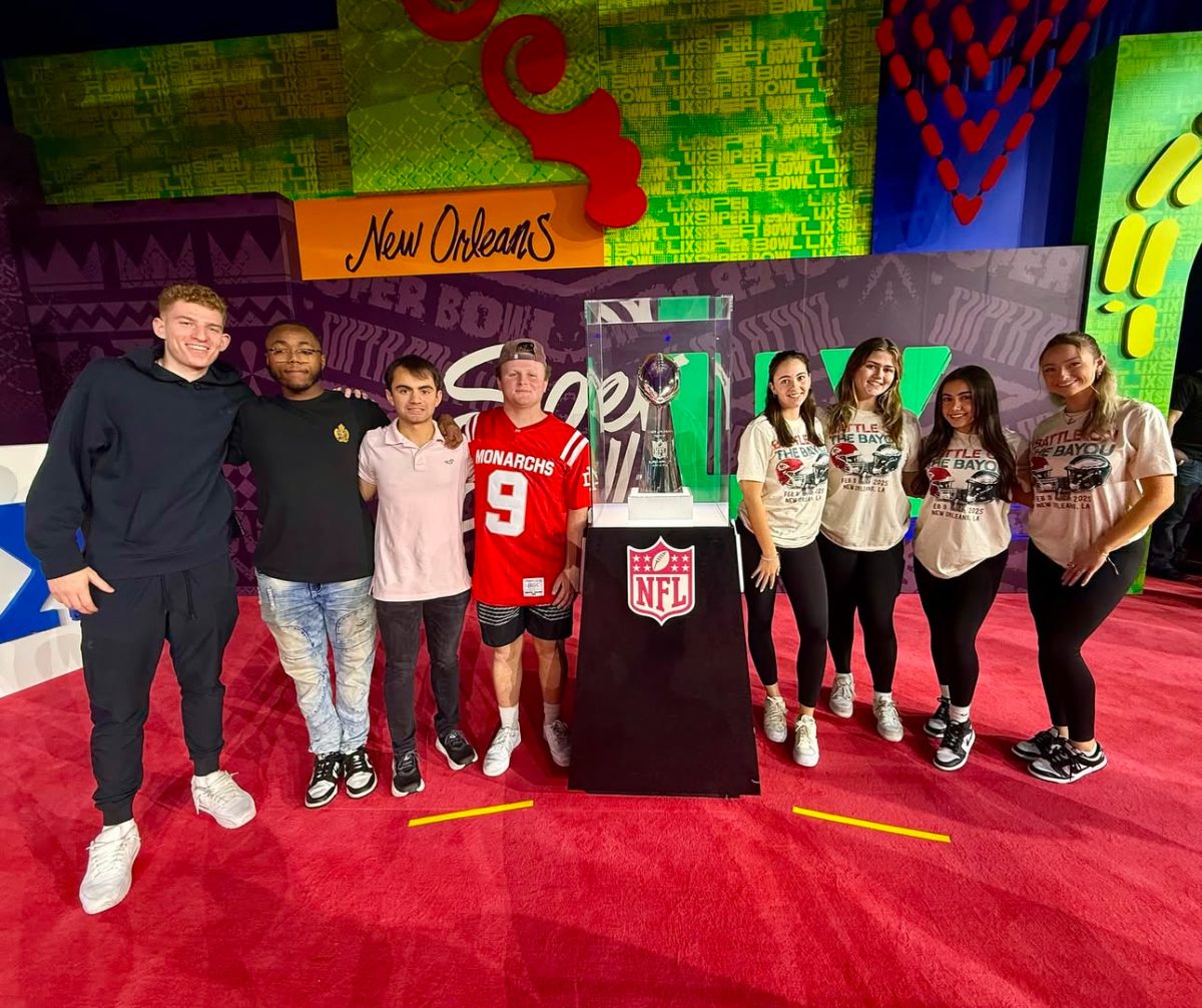 From left to right, Rob Obdyke, Ray Simmons, Alex Brown, Grady Stefankiewicz, Kerri Letizia, Caitlin Sandusky, Bailey Livezey, and Jenna Koskinen pose with the Vince Lombardi Trophy. - Photo via @rowansportscam on Instagram