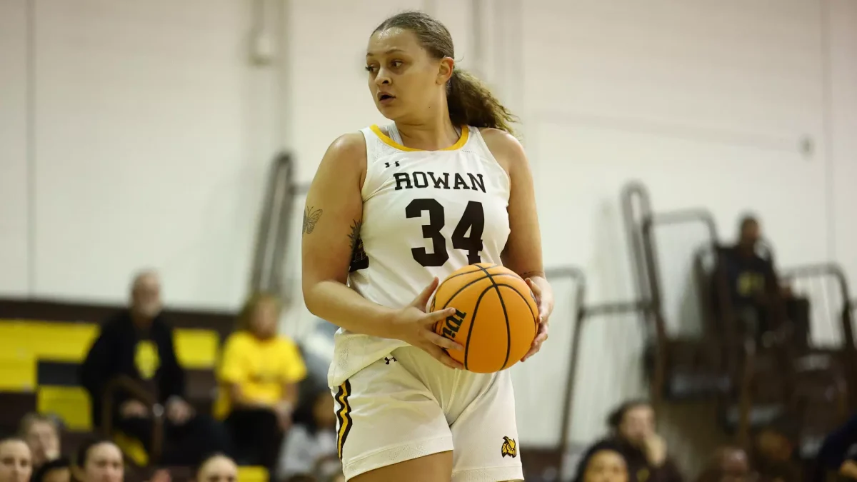 Shayla Johnson grabs the ball. Johnson recorded 14 points in the loss. - Photo via Rowan Athletics