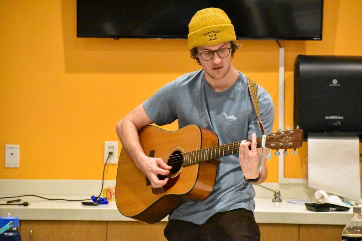 Kenneth Trautweiler plays acoustic guitar at the Holly Jam in Holly Point's conference room, Glassboro, NJ. Thursday, February 20, 2025. - Staff Photographer / Owen Miller