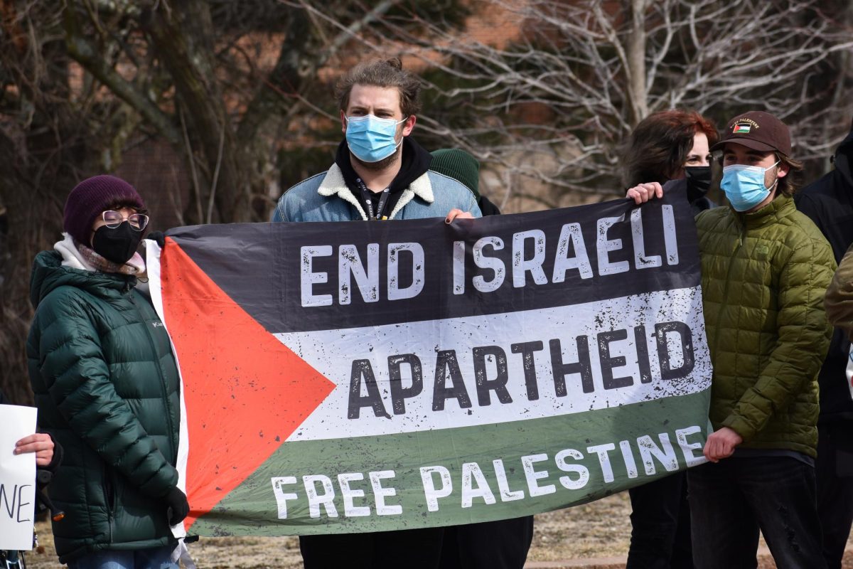 Rowan students hold a Palestinian flag to protest SJP's discontinuation in front of the owl statue on campus, Glassboro, NJ. Tuesday, February 18, 2025. - Staff Photographer / Owen Miller