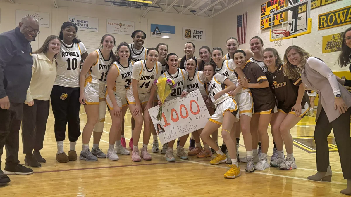 The Profs celebrate Kate Herlihy reaching 1,000 career points. - Photo via Rowan Athletics