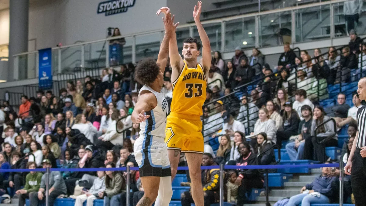 Danny Fleming shoots a three-pointer. Fleming was the Profs' second-leading scorer against Stockton with 17 points. - Photo via Rowan Athletics