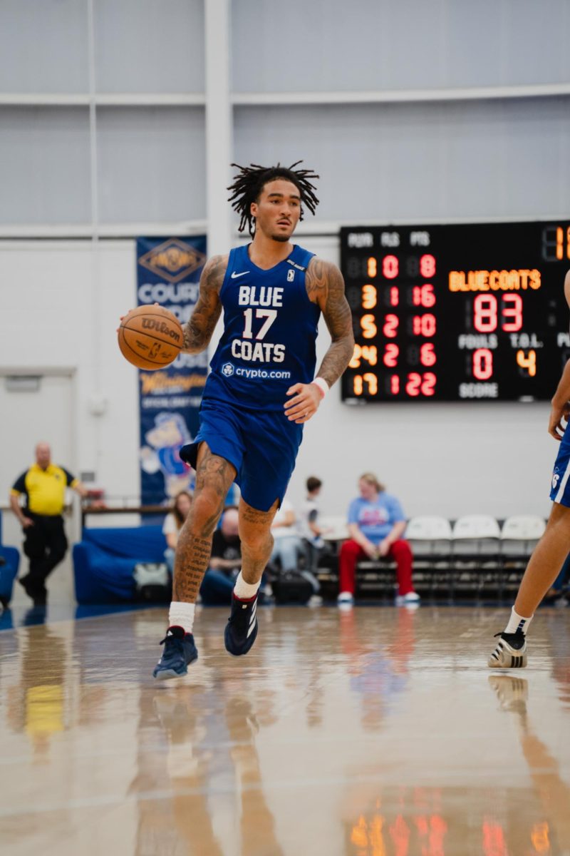 Jalen Hood-Schifino scans the court. The two-way player scored 18 points in his Blue Coats debut. - Photo via Shamar Swann