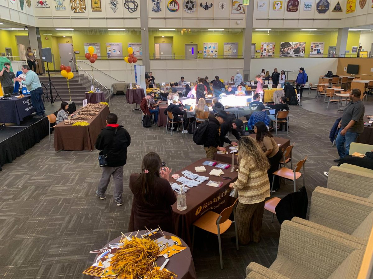 Brown and gold prof inspired tables filled the pit of the Student Center as Rowan clubs and organizations participated in Rowan’s Day of Giving. 
- Productions Editor / Katie Thorn