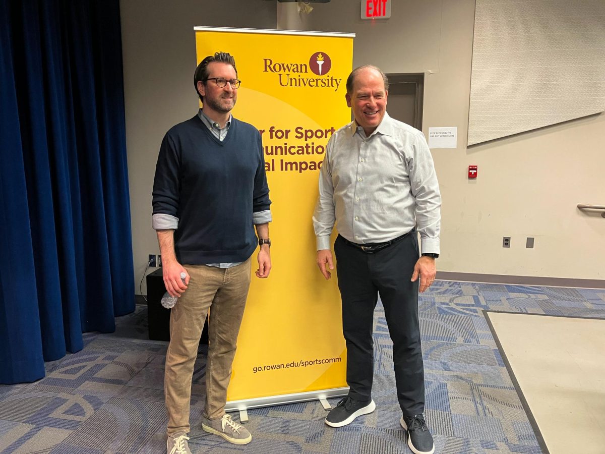 Kevin Kurz, left, poses for a photo with Sports Communication and Social Impact senior director Neil Hartman, right, after Pizza with the Pros. Glassboro, NJ. Monday, March 3, 2025. - Staff Writer / Gerasimos Gerovasiliou