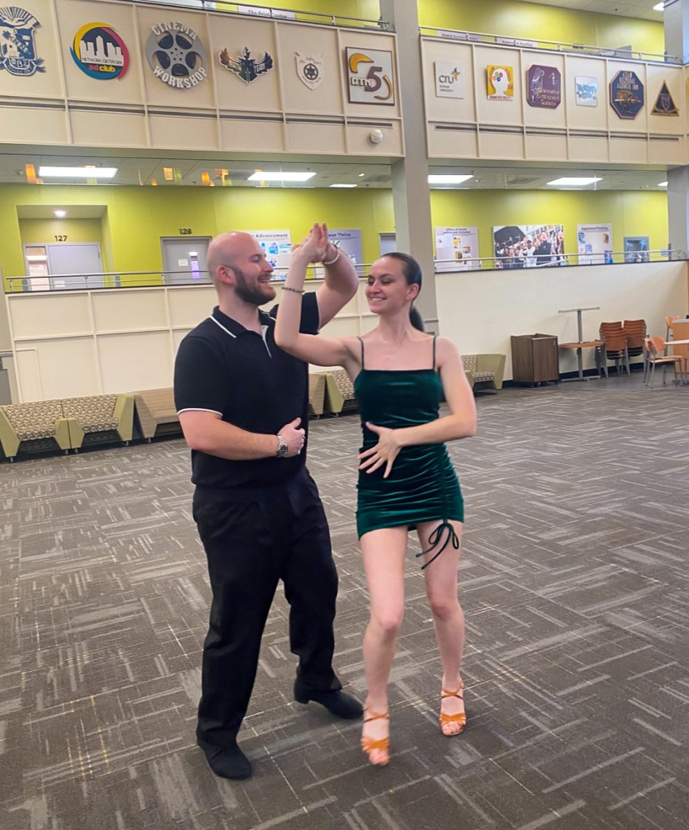 Rowan alumni and dancers James Hambor, left, and Valerie Monzo, right, swing dance in the Chamberlain Student Center. Glassboro, NJ. Tuesday, March 12, 2025. - Staff Photographer / Kacie Scibilia