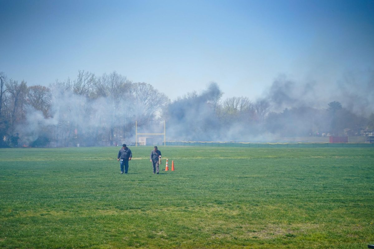 Glassboro public schools grounds supervisor Sam Paranello, left, and another groundskeeper walk away from the fire at the Glassboro High School. Glassboro, NJ. Thursday, April 17, 2025.