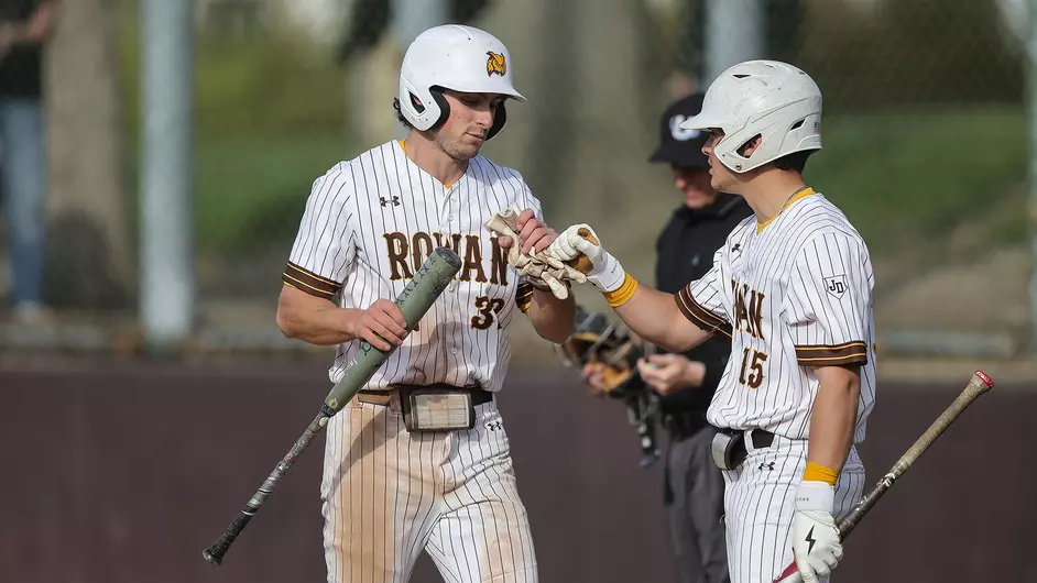 Phil Sedalis fist bumps Dave Appolonia. The senior hit two home runs, one being a grand slam, versus Rutgers-Newark. - Photo via Rowan Athletics