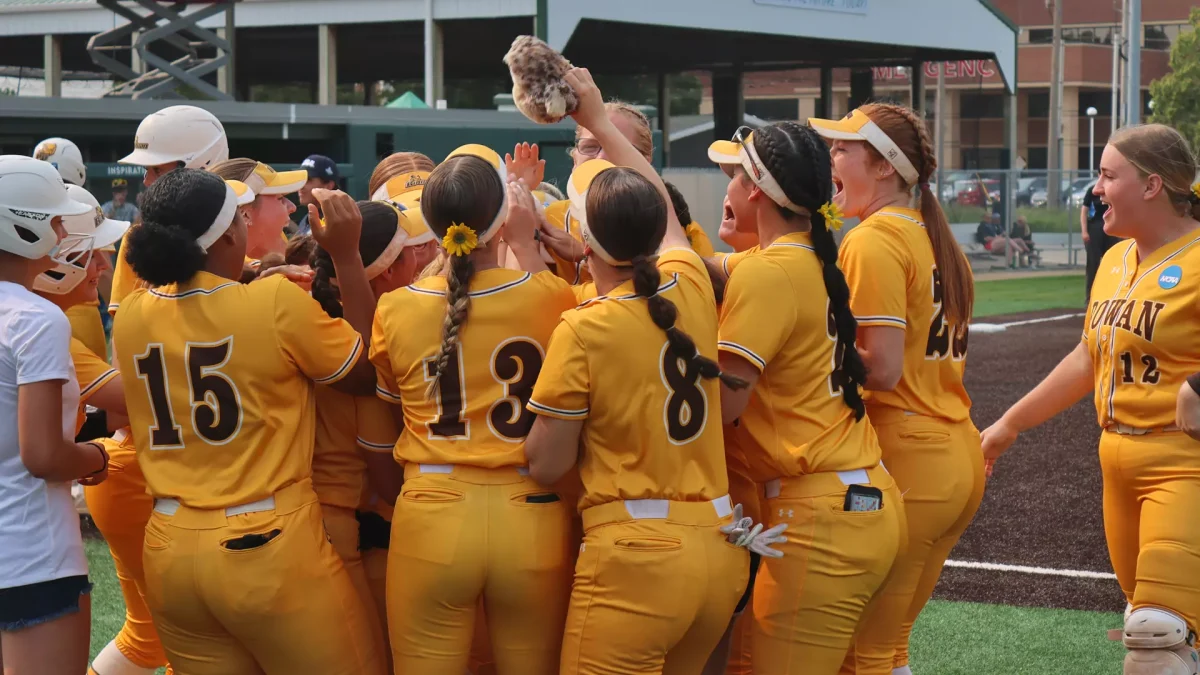 Liz McCaffery's teammates celebrate at home plate after she hit her home run. Despite homering in back-to-back games, the Profs suffered their first loss of the NCAA Division III Softball Championship at the hands of Trine. Bloomington, Ill. Friday, May 30, 2025. - Photo via Rowan Athletics