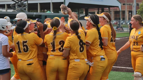 Liz McCaffery's teammates celebrate at home plate after she hit her home run. Despite homering in back-to-back games, the Profs suffered their first loss of the NCAA Division III Softball Championship at the hands of Trine. Bloomington, Ill. Friday, May 30, 2025. - Photo via Rowan Athletics
