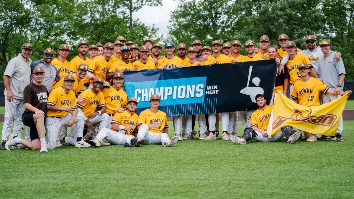 The Rowan baseball team poses with their NCAA Regional Champs banner. The Profs will now travel to Lynchburg, Virginia, for their first Super Regionals appearance since 2023. Alliance, OH. Sunday, May 18, 2025. - Photo via Rowan Athletics