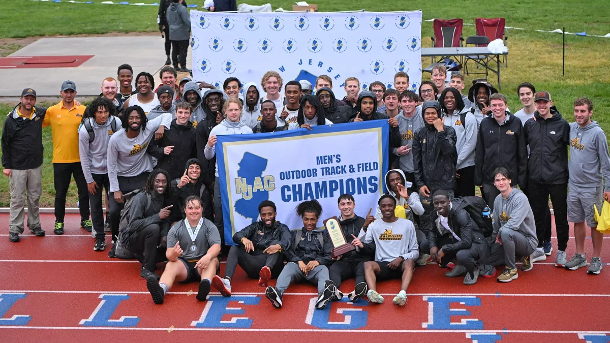 The Rowan men's outdoor track and field team poses with their NJAC Champions banner. The program has now won 10 straight conference titles. -  Photo via Rowan Athletics