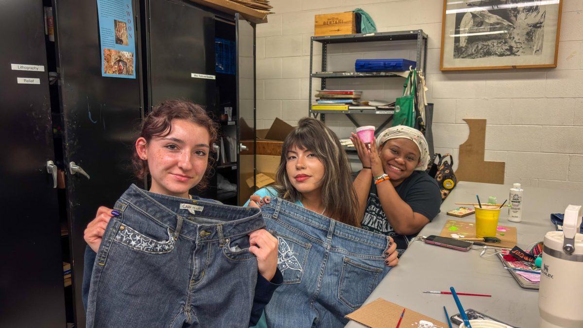 Students proudly show off their hand-painted creations during WOW's fabric painting event, where they turned old clothes into fresh designs. Wednesday, Sept. 17, 2025. Glassboro, NJ. (Jaziya McDonald / Staff Writer)