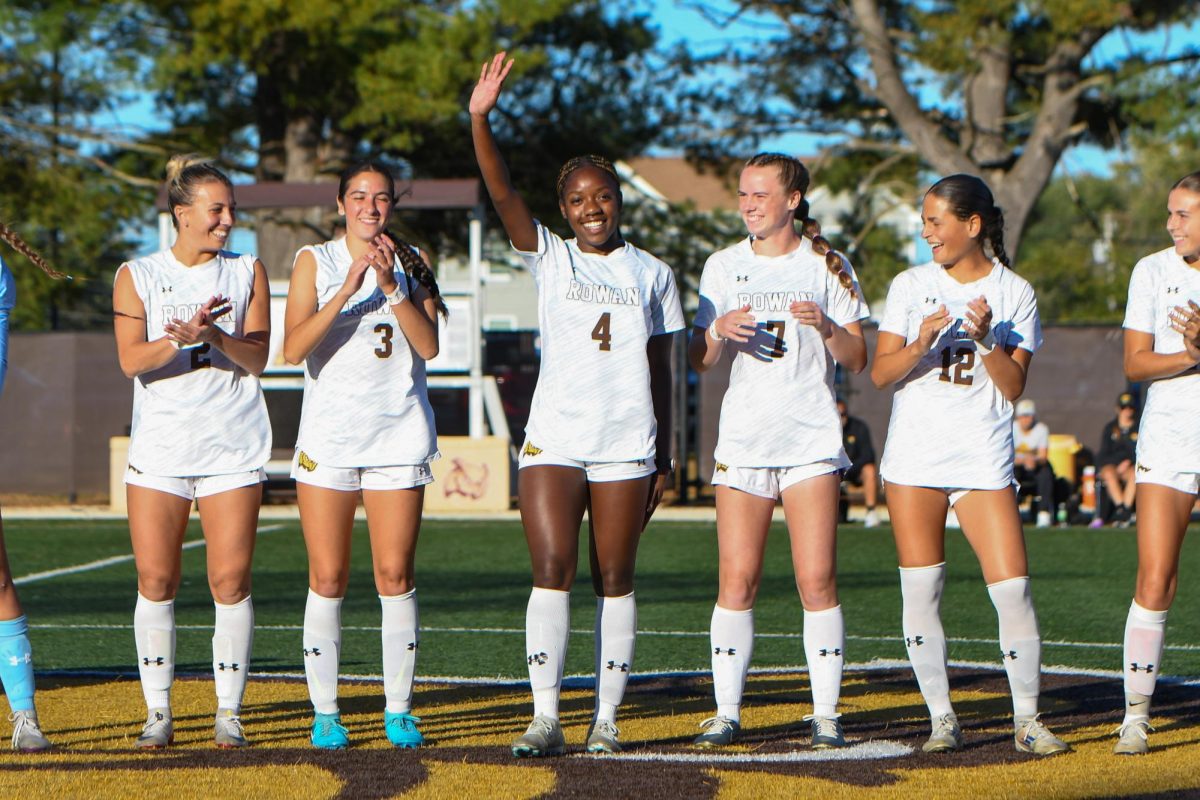 Angelo Oliveto (left) claps for MaKala Baker (right) during player introductions. Glassoro, N.J. Wednesday, Oct. 8, 2025. (Sports Photographer / Trevor Miceli)