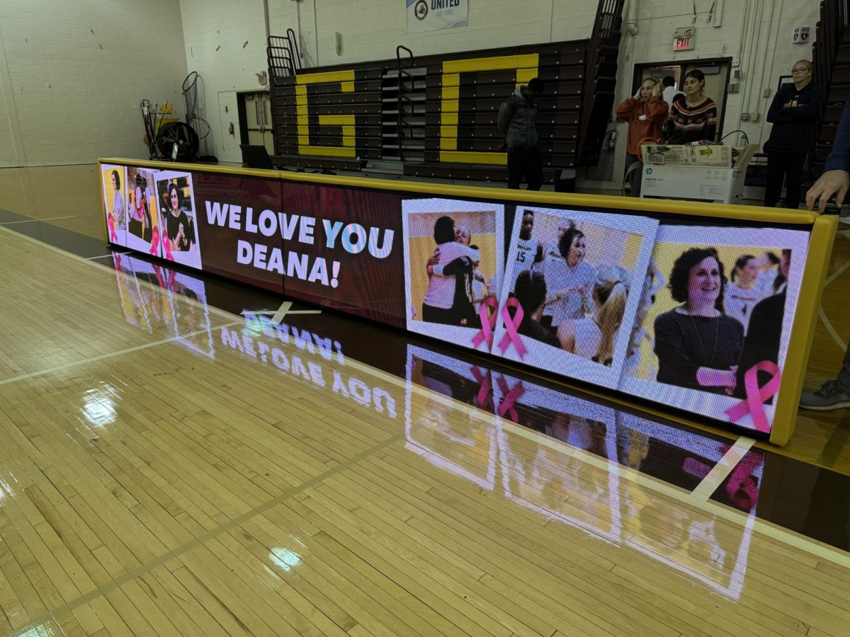 A "We Love You Deana" sign projected on the screen of the scorer's table inside Esbjornson Gymnasium. Glassboro, N.J. Tuesday, Oct. 28, 2025.