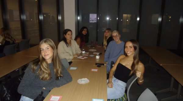 Her Campus members pose at meeting. (Photographer - Kaila Casco)