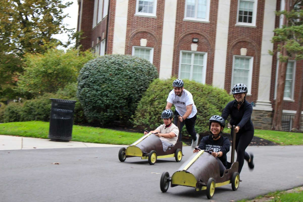 Members of the Rowan Bowling Club and Club Field Hockey racing towards the finish line during the first races of the Push Cart Competition. Tuesday, Oct. 14, 2025. Glassboro, NJ. (Christopher Otto / Photography Editor)