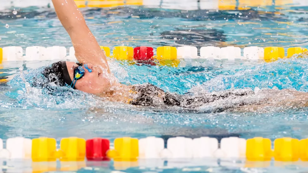 Ella Pennington competes in the back stroke. Pennington set a new Montclair State pool record on Friday with her time in the 100 Backstroke. (Rowan Athletics)