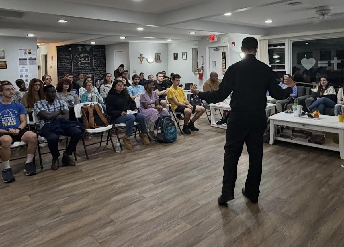 Students watch Father Thomas Piro give a presentation on his life and vocation. (Catholic Campus Ministry via Instagram)
