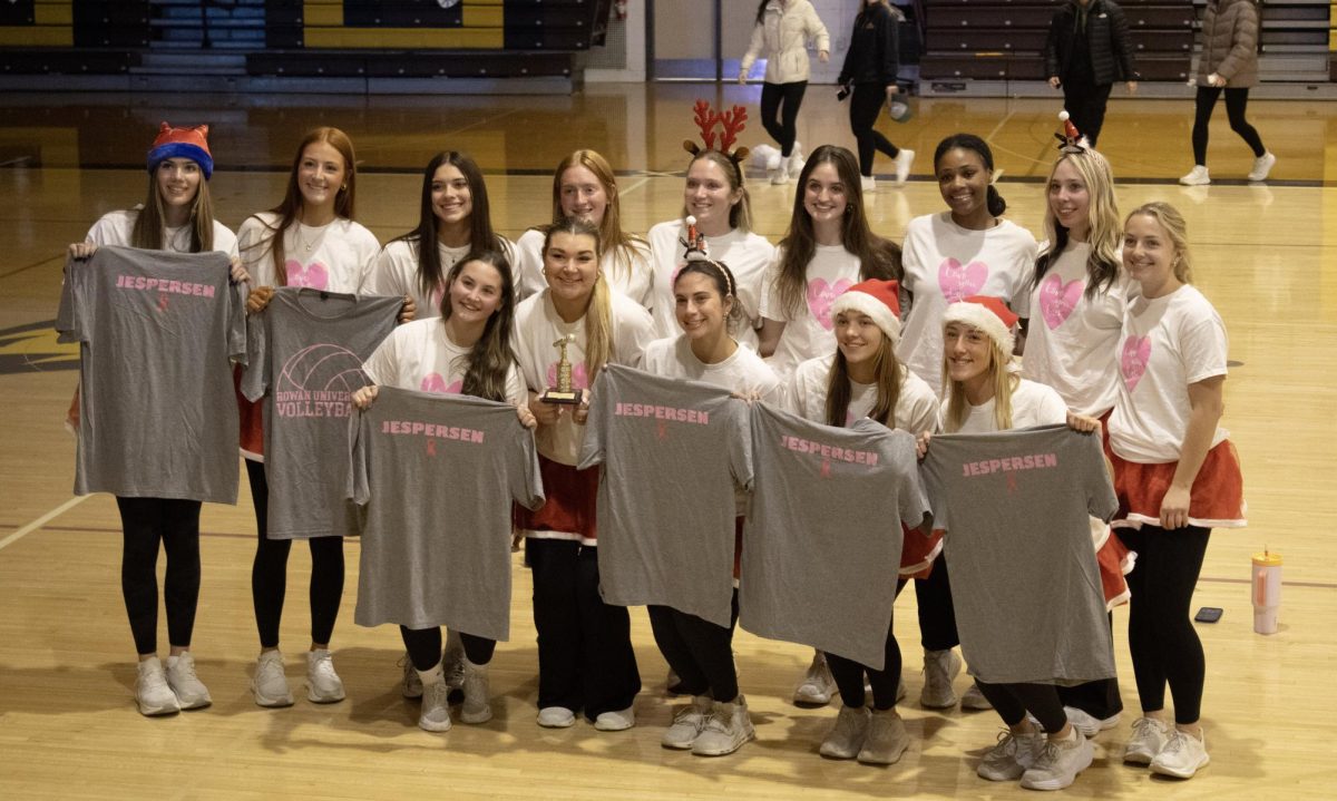 Rowan Volleyball pose with their first place trophy and Deana Jesperson shirts at the Student athlete Lip Sync battle Dec. 9, 2025. (Staff Photographer / Melanie Barahona)