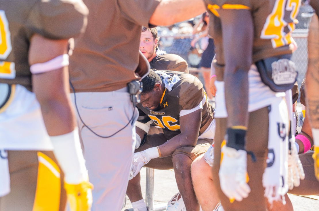 Giaini Derameaux sits on the bench during Rowan Football's game against Christopher Newport. Glassboro, N.J. Saturday, Oct. 4, 2025 (Sports Photographer / Shelby Kauffman)