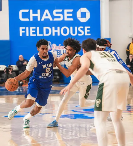 Saint Thomas dribbles the basketball. (Delaware Blue Coats)