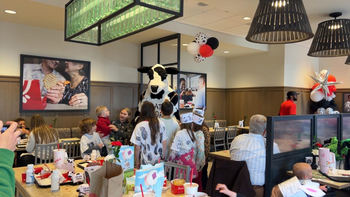 Chick-fil-A cow mascot comes out to take pictures with kids in their cow print. (Copy Editor / Sofia Graiff)