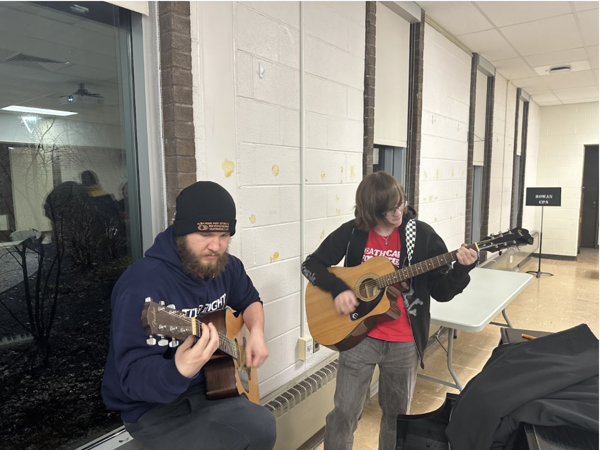 Two students play guitar together as part of a jam session after the meeting. Feb. 20, 2026. (Staff Writer/ Seamus Tierney)
