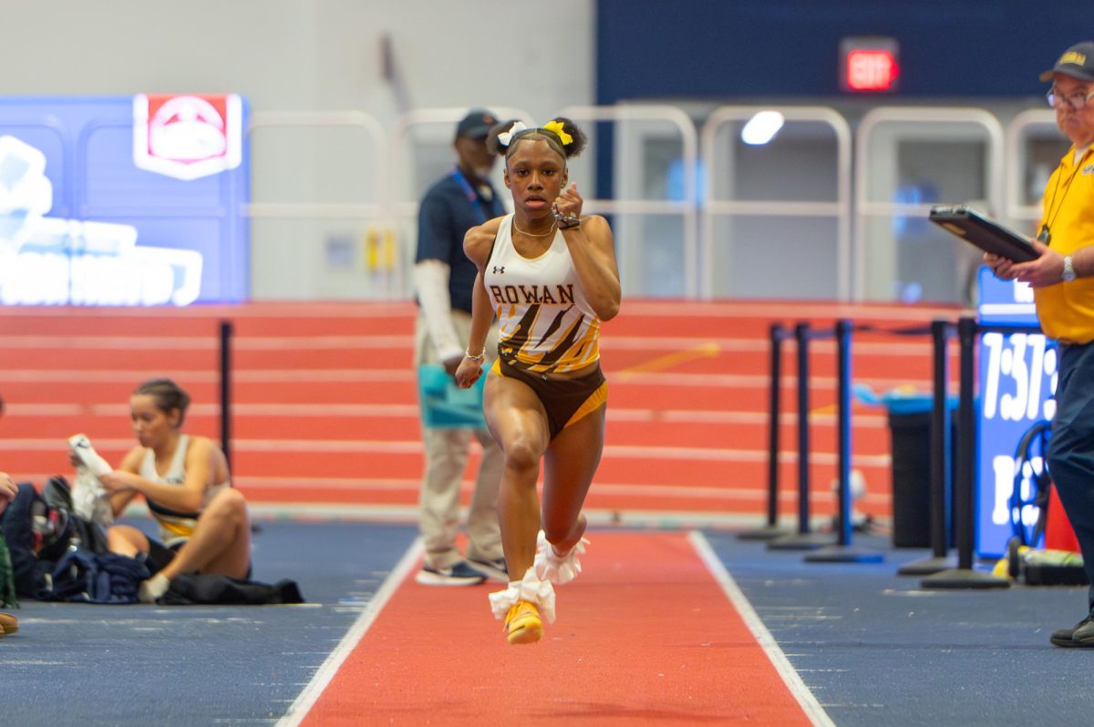 Denirah Jones runs before the long jump. Jones finished fifth in the long jump at the AARFTC Championships. (Sports Photographer / Trevor Miceli)
