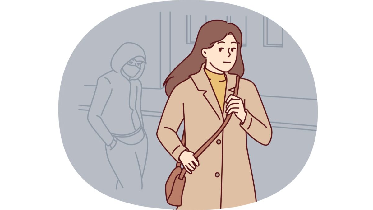A graphic with a woman walking. An outline of a masked man is following behind her. (Graphics Editor / Alexander Cruz)
