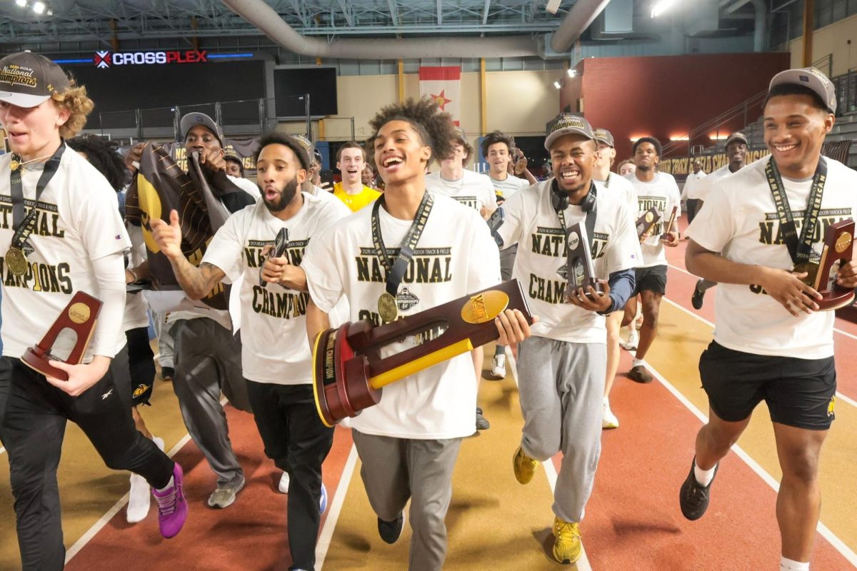 Elijah Hendricks carries the NCAA trophy on track at the Birmingham CrossPlex with teams Noah Wampole, Jarquill Young, Joshua Justin and Arrington Rhym  (Sports Beat Writer / Luke Brown)