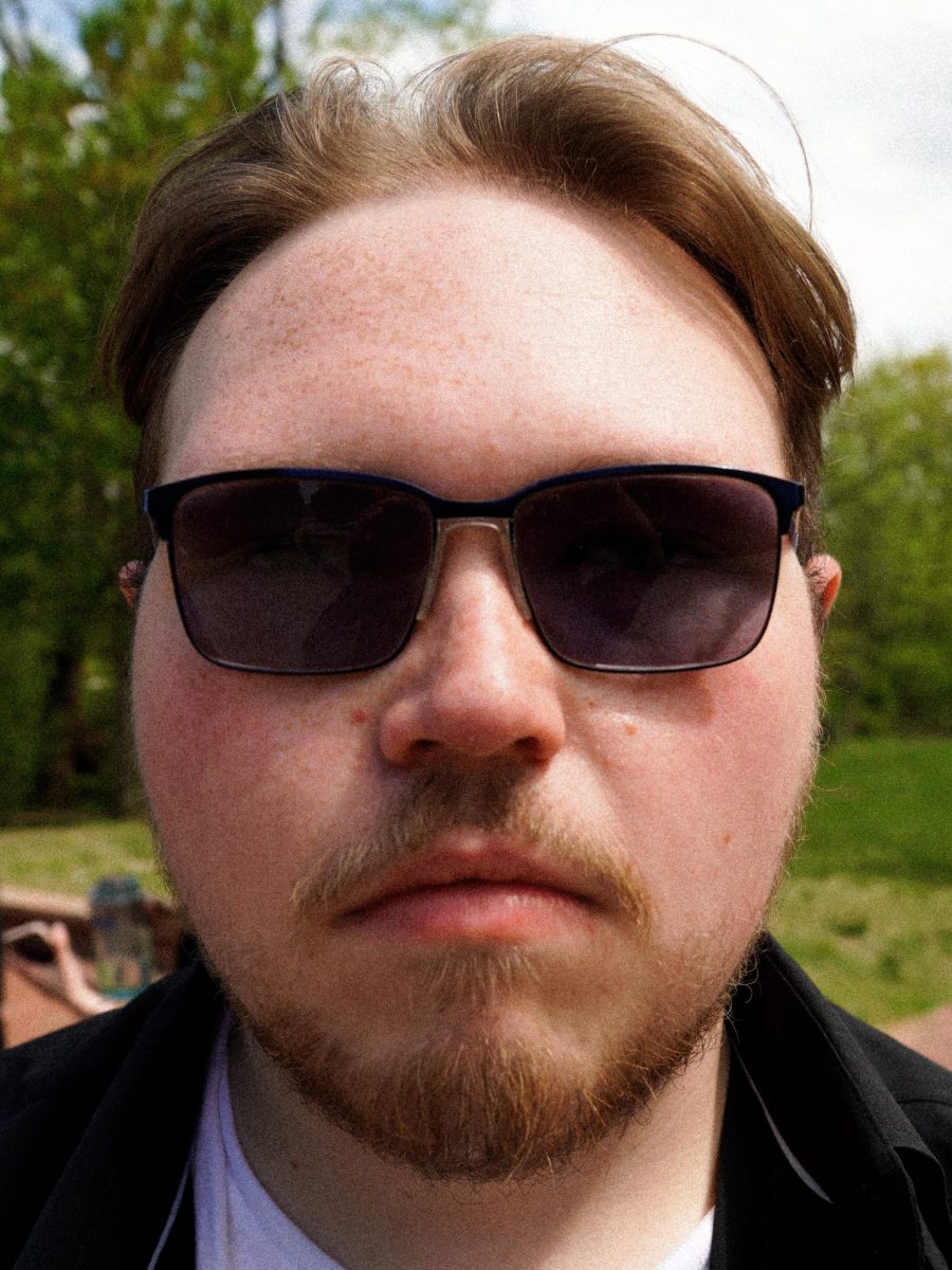 A photograph of Christopher Otto staring at the camera with sunglasses on. Taken during the "Meet Chris" event, April 17 2026. (Staff Writer / Nick DiCicco)