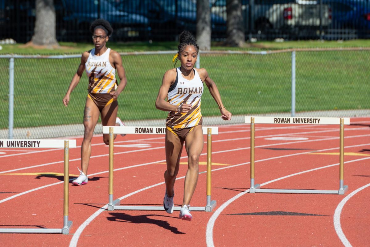 Nyla Jones competes in the hurdles. Jones secured two top five times in Division III in the hurdles last weekend. (Sports Photographer / Trevor Miceli)
