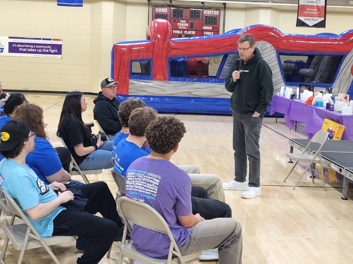 Rowan math professor Dr. Christopher Lacke speaks to attendees of Relay for Life about his experiences with cancer. (Staff Writer / Miles Morris)