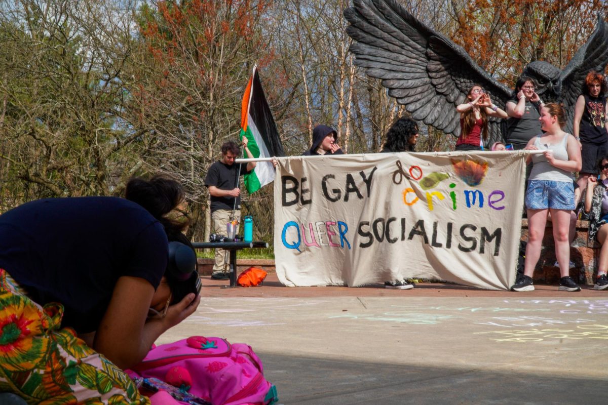 Protesters hold up a pro-LGBTQIA+ banner in front of the Owl Statue. Wednesday, April 1, 2026. Glassboro, N.J. (Staff Writer / Nick DiCicco)
